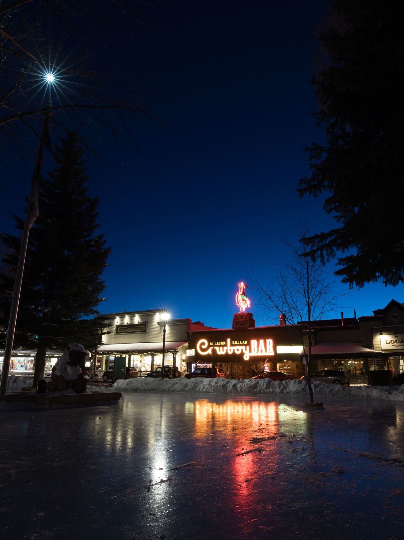 Cowboy Bar at night from ice rink with cool reflection
