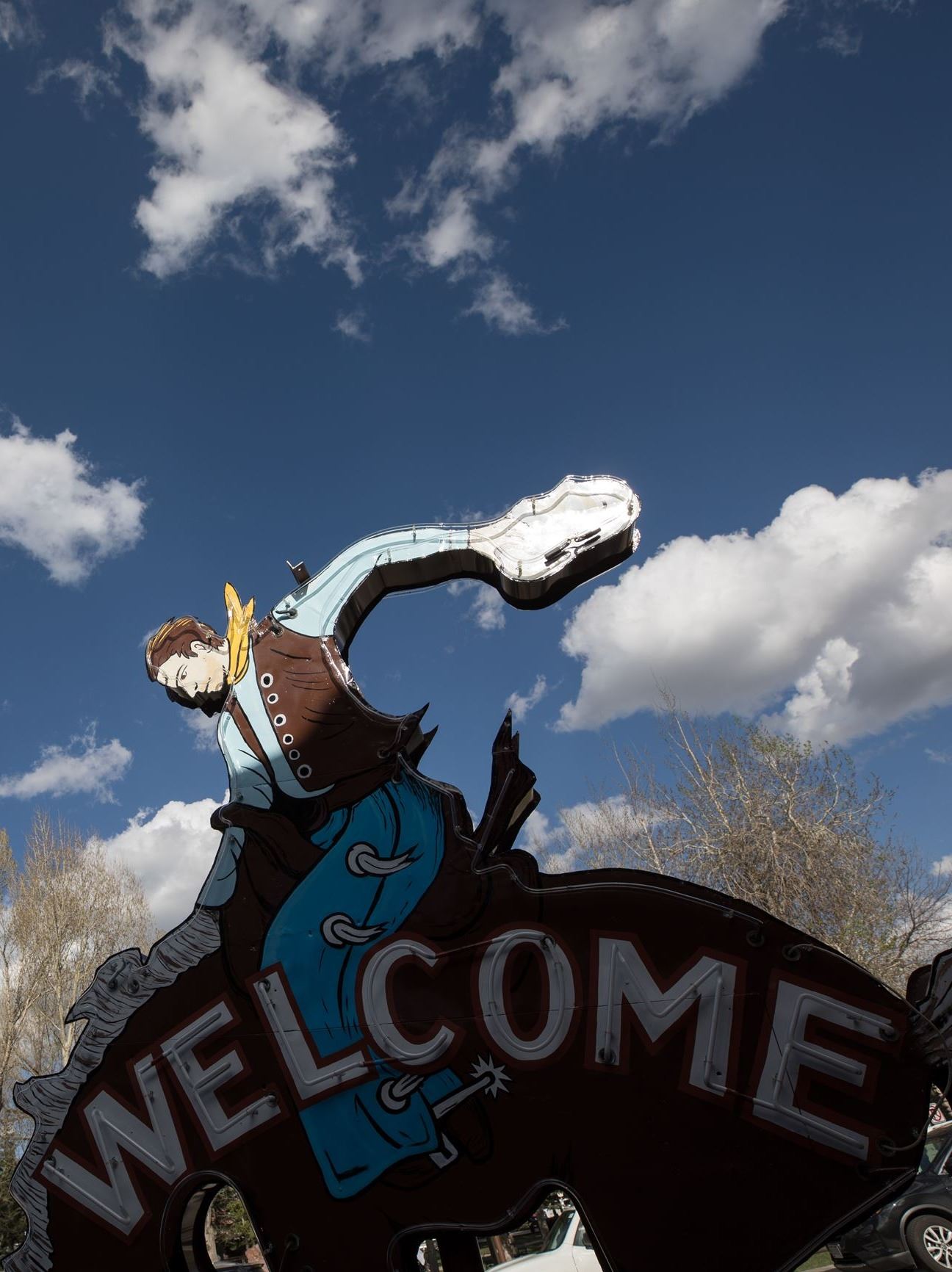 Cowboy sign and clouds
