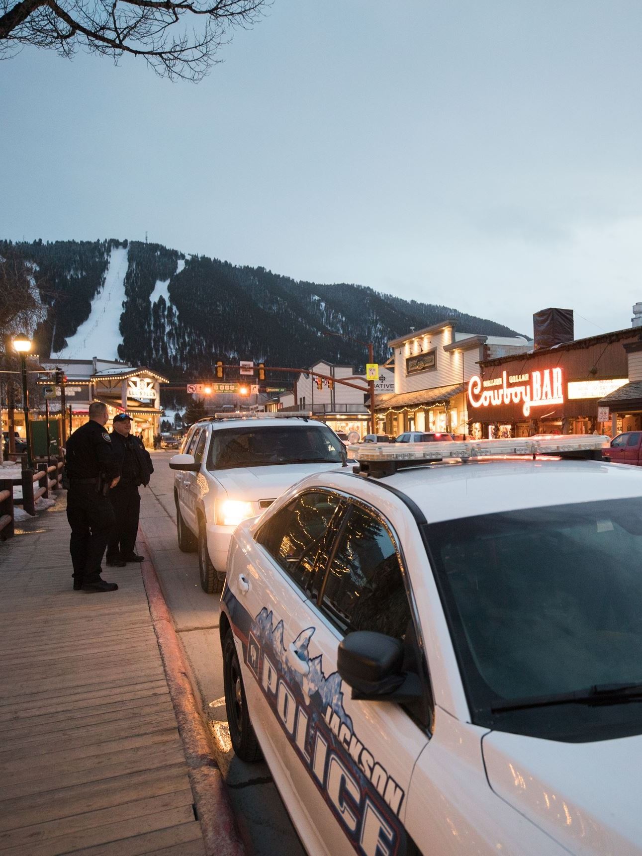 Police Squad car at dusk town square snow on Snow king