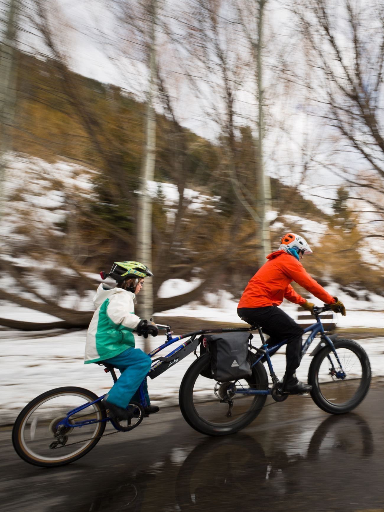 Bike path in town garaman park with snow and wet path