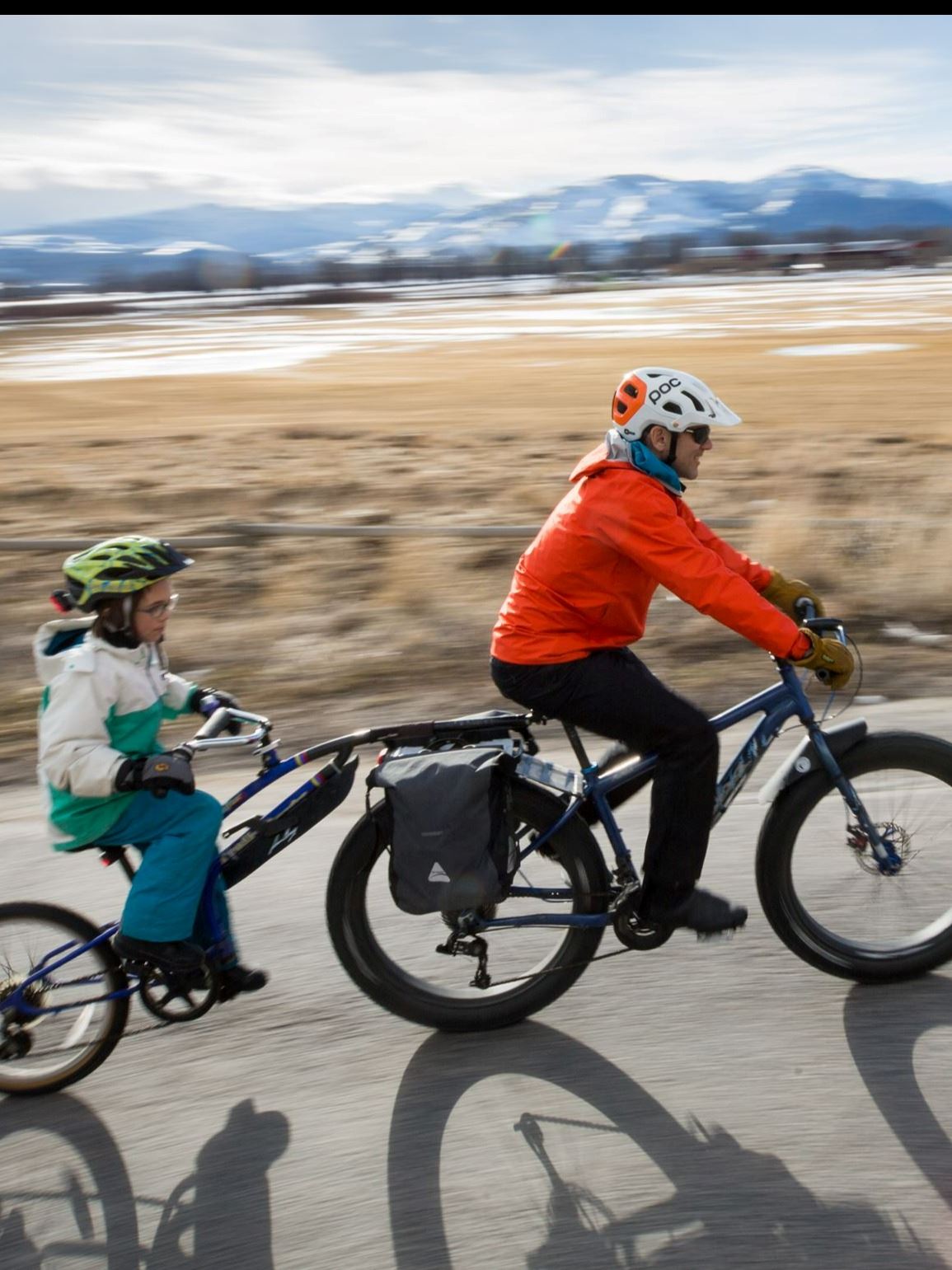 Bike path north with some snow and blurred mountains