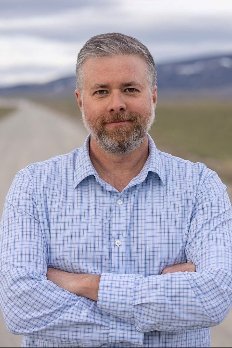 A photo of Kevin Regan standing on the Elk Refuge Road